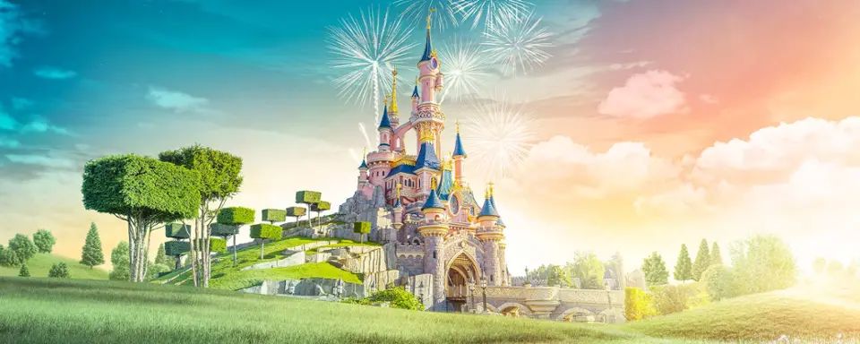 Sleeping Beauty Castle illuminated beneath a sky of fireworks.