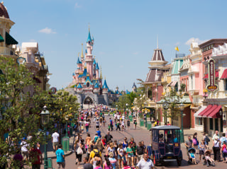 Main Street, U.S.A. leads between colourful façades toward Sleeping Beauty Castle.