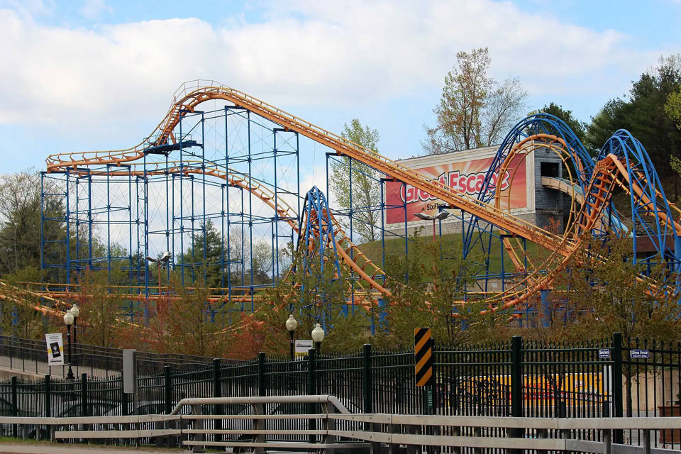 General view of Great Escape from Route 9, with the park sign and Steamin’ Demon above the trees.