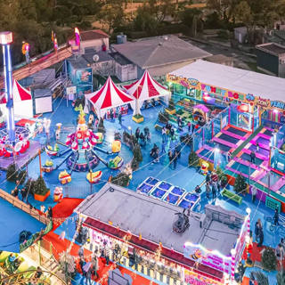 Aerial view of Funnyland lit up, with Les Soucoupes in the centre and Funny Box on the right.