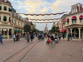 Visitors follow the tram tracks along Main Street, U.S.A. toward the castle.