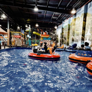Small boats on Adventure World’s indoor pool