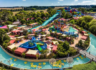 Vista aérea do Adventure Park Geelong com o lago, as áreas aquáticas e vários escorregas de grande porte.