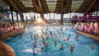 Panoramic view over the Surf Fjørd wave pool, the vast glass wall and the Nordic scenery inside Rulantica.