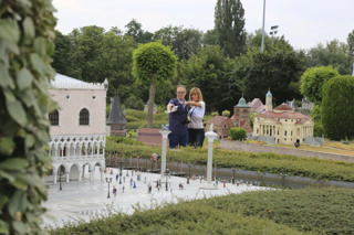 Visitors explore European scenes among the gardens