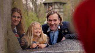 A family discovers the Little Red Riding Hood scene in the Fairytale Forest.