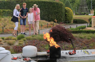 A family activates an animated scene in the miniature park